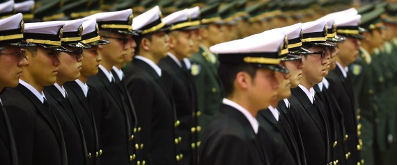 Graduates of the National Defense Academy wearing uniforms of the Self-Defense Forces attend their cadet appointment ceremony in Yokosuka, Kanagawa Prefecture on March 22, 2015. A total of 492 students graduated from the school this year. AFP PHOTO / KAZUHIRO NOGI (Photo credit should read KAZUHIRO NOGI/AFP/Getty Images)